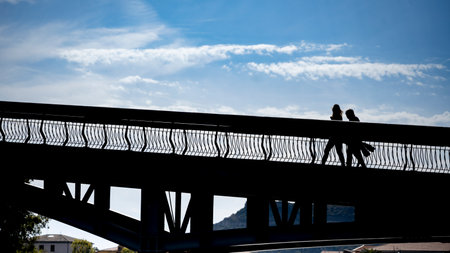People walking across a bridge in the town of Bosa which is situated about two-thirds of the way up the west coast of Sardinia, Italyのeditorial素材