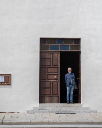 Man standing in the doorway of a building, Santa Teresa Gallura, Sardinia, on the Strait of Bonifacio, in the province of Sassariのeditorial素材