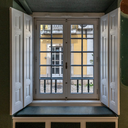 Interior view of doors leading to a balcony in a building in SetÃºbal which is a busy port and industrial city in Portugal that boasts an extensive history and rich seafaring heritageのeditorial素材