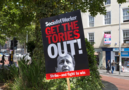 Bristol, UK - May 30, 2015: A placard with the slogan âGET THE TORIES OUTâ and a photograph of prime minister David Cameron at a demonstration shortly after the general electionのeditorial素材