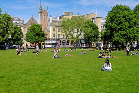 Bristol, UK - May 22, 2017: Sunbathers on College Green take advantage of the fine weather on a...