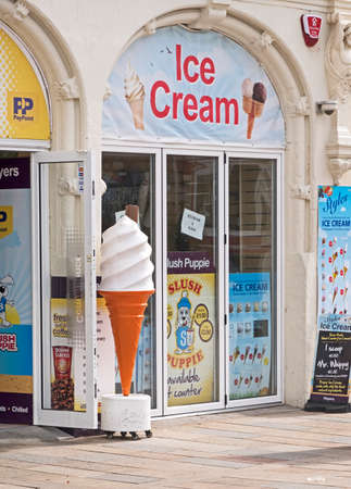 Weston-super-Mare, UK - June 16, 2016: An oversized plastic ice cream cone outside a shop on the seafrontのeditorial素材
