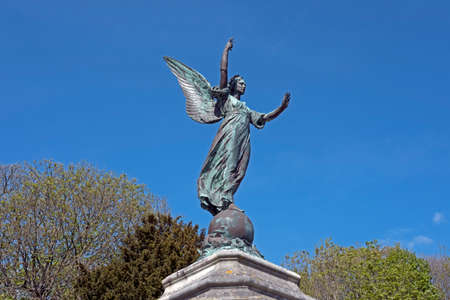 Weston-super-Mare, UK - April 23, 2017: A statue of a winged Victory by Alfred Drury which surmounts the war memorial in Grove Park. The memorial is pictured before restoration.のeditorial素材