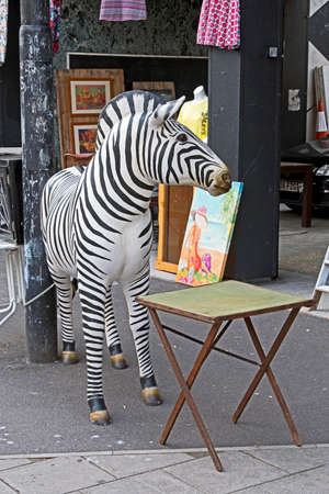 Bristol, UK - August 17, 2017: A carved wooden a zebra stands outside a secondhand shop in the Stokes Croft areaのeditorial素材