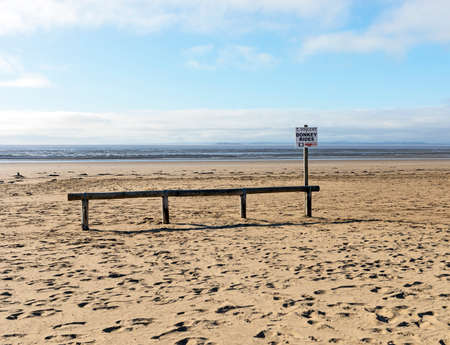 Weston-super-Mare, UK - September 24, 2021: A sign adverising donkey rides on the beachのeditorial素材
