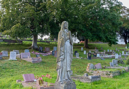 Weston-super-Mare, UK - October 9, 2021: A female figure on a grave in Milton Road Cemeteryのeditorial素材