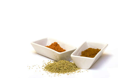 paprika and tandoori spices in bowls on a white background