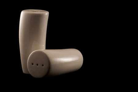 modern, stylish salt and pepper pots on a black backgroundの写真素材
