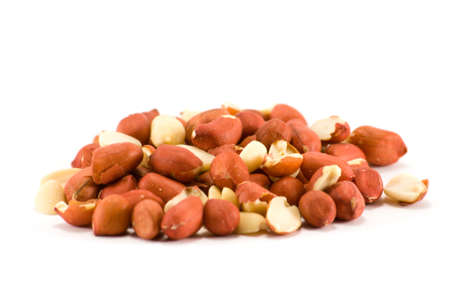 A small pile of red skin peanuts on a white background