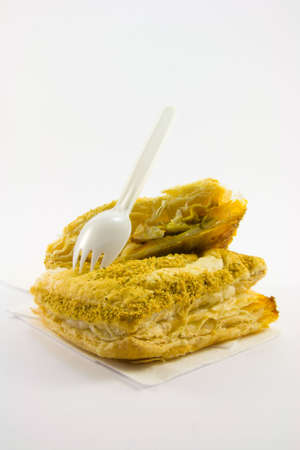Single chicken curry pasty with plastic white fork on a white backgroundの写真素材