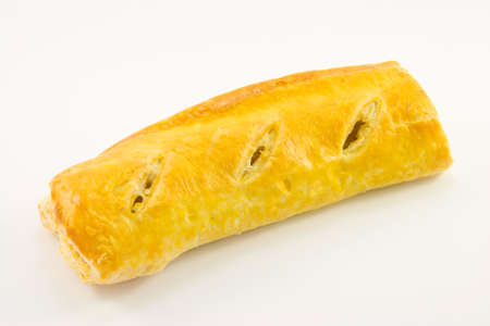 Single whole golden sausage roll on a white backgroundの写真素材