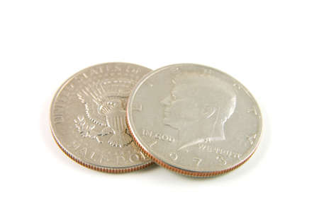 closeup of two american 1973 half dollars showing bot the head and tail sides on a white background
