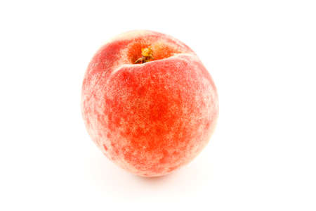 single red ripened peach with a short stalk on a white backgroundの写真素材