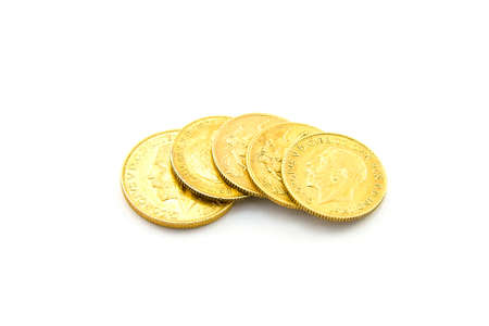 Four half sovereigns and one sovereign on a white backgroundの写真素材