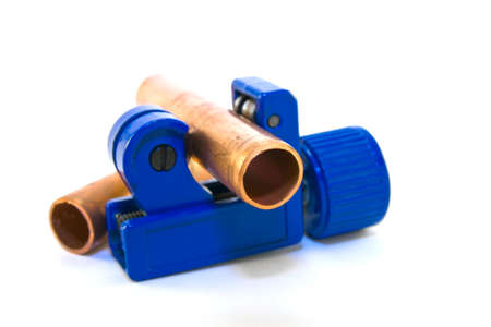 Single blue pipe cutter with pipes on a white backgroundの写真素材