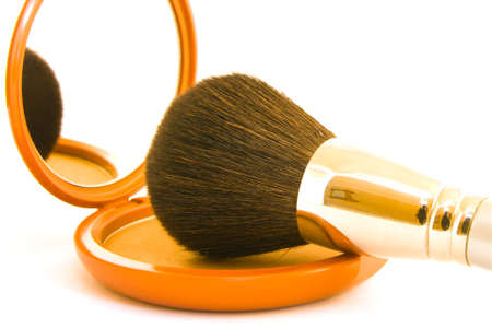 Bronze face powder in a compact with brush on a white backgroundの写真素材