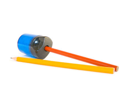 Orange and yellow pencils with sharpener on a white backgroundの写真素材