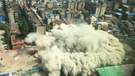 Downtown building demolition by controlled implosion in China