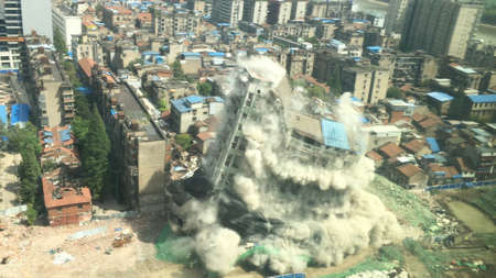 Downtown building demolition by controlled implosion in China