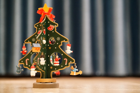 Painted wooden christmas tree with blue background and copy space                       の写真素材
