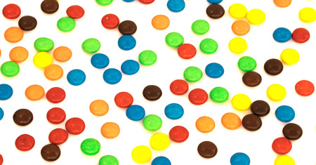 colorful button shaped chocolates candy isolated on white background