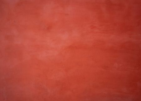Red painted wall background with washed-out colorの写真素材