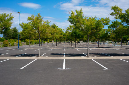 Beautiful empty Parking lot with trees on sunny summer day in Franceの写真素材