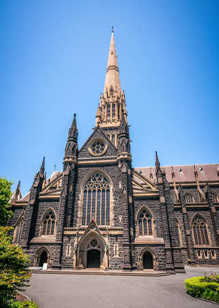 Side view of St Patrick's Cathedral and spire a Roman Catholic Cathedral church in Melbourne Victoria Australiaの写真素材