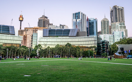 23rd December 2018, Sydney NSW Australia : Grassy place at Tumbalong park at dusk with Sydney skyline in background in Darling Harbour NSW Australiaのeditorial素材