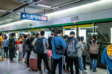 6 April 2019, Wuhan Hubei China : Chinese people waiting for the subway in an underground station on...