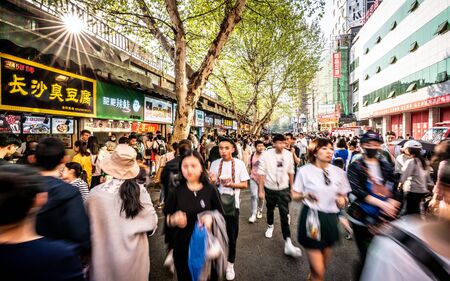 6 April 2019, Wuhan Hubei China : Moving forwad crowd of Chinese people in streetfood street in Wuhan Hubei Chinaのeditorial素材