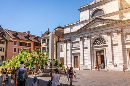 7 August 2018, Annecy France : Tourists in the street of old Annecy city with the facade of church Notre Dame de Liesse in Annecy Franceのeditorial素材