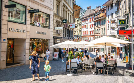 Lausanne Switzerland, 25 June 2020: Rue de Bourg a pedestrian shopping street in old Lausanne with people on a restaurant terrace enjoying 2020 summer in Lausanne Vaud Switzerlandのeditorial素材