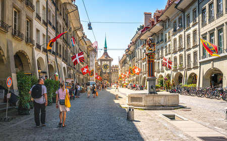 Bern Switzerland, June 27, 2020: Tourists in old Kramgasse street with Simsonbrunnen or Samson fountain and Zytglogge clock tower in Bern old town Switzerlandのeditorial素材