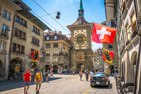 Bern Switzerland, 27 June 2020: Old street view with tourists flags and Zytglogge clock tower in Kramgasse street in Bern old town Switzerlandのeditorial素材