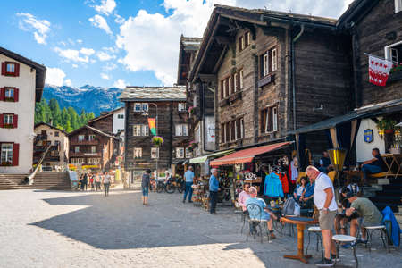 Zermatt Switzerland, 2 July 2020: Cafe terrace with tourists and old houses during summer in Zermatt Switzerlandのeditorial素材