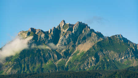 Pilatus kulm mountain summit remote view taken from Lucerne during summer with clear blue sky in...