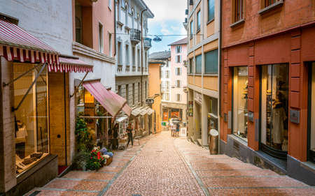 Lugano Switzerland, 1 July 2020: Pedestrian Via Cattedrale sloped shopping street of Lugano with colorful houses in Ticino Switzerlandのeditorial素材