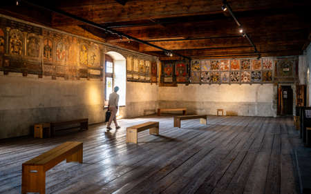 Veytaux Switzerland, 4 July 2020: Medieval room inside Chillon castle and tourist passing in front of a window in Vaud Switzerlandのeditorial素材
