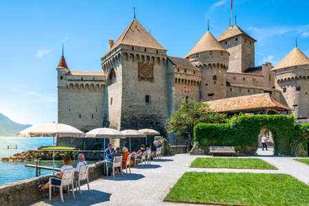 Veytaux Switzerland, 4 July 2020: People resting and admiring the view on Geneva lake on sunny summer day and Chilllon Castle in background in Switzerlandのeditorial素材