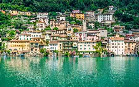 Scenic view of Gandria colorful fishing village houses on the shore of Lake Lugano on beautiful...