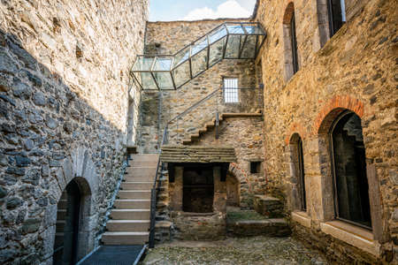 Courtyard and entrance of museum in middle of Montebello castle church in Bellinzona Ticino Switzerlandのeditorial素材