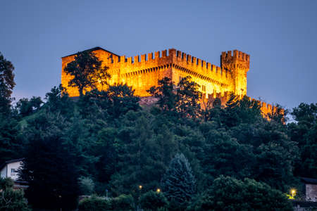 Distant view of Sasso Corbaro medieval castle illuminated at night in Bellinzona Ticino Switzerlandのeditorial素材