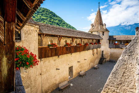 View of Aigle castle from wall walk with flowers and tower during summer in Aigle Vaud Switzerlandのeditorial素材
