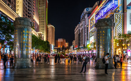 Kunming China, 3 October 2020: Nanping pedestrian shopping street illuminated at night with famous columns in Kunming Yunnan Chinaのeditorial素材
