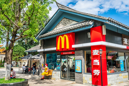 Kunming Yunnan China, October 3, 2020: McDonalds restaurant entrance with logo and name in Chinese characters in a traditional architecture building in Chinaのeditorial素材
