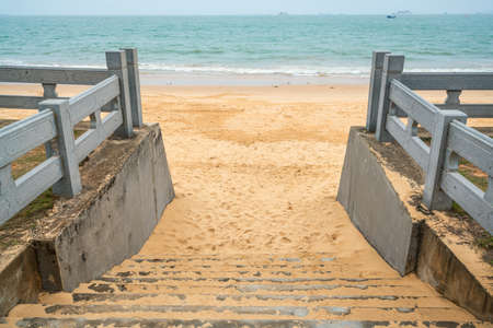 Stairs leading to beautiful Holiday Jiari beach and sea view in Haikou Hainan Chinaの写真素材