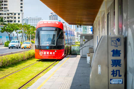 Sanya China, 24 March 2021: Sanya red light rail tramway leaving a station in Sanya Hainan China