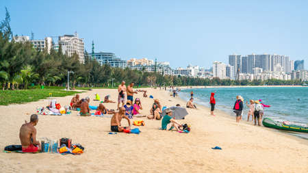 Sanya China, 24 March 2021: Many Chinese tourists on Sanya beach and city view in Sanya Hainan island Chinaのeditorial素材
