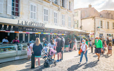 30 July 2021, Saint-Martin-de-RÃ© France: Tourists queuing-up at La MartiniÃ¨re ice-cream maker shop in Saint-Martin-de-RÃ© old port a famous local artisan on RÃ© island Franceのeditorial素材